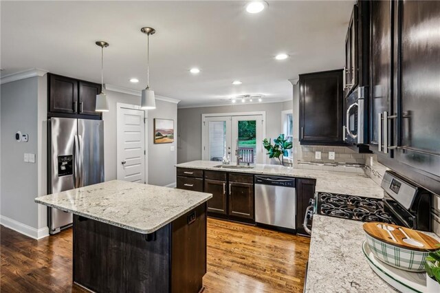 1735 Jobeth Ave SE, Atlanta, GA 30316 - kitchen featuring stainless steel appliances, ornamental molding, wood finished floors, recessed lighting, and decorative backsplash