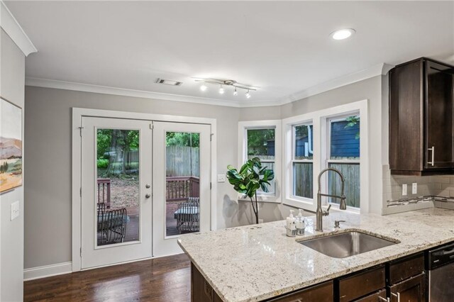 1735 Jobeth Ave SE, Atlanta, GA 30316 - kitchen featuring dark brown cabinets, stainless steel dishwasher, dark wood-type flooring, healthy amount of natural light, and crown molding