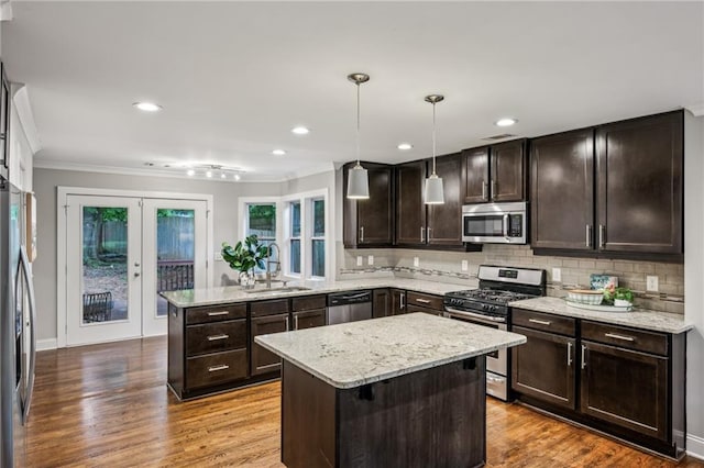 1735 Jobeth Ave SE, Atlanta, GA 30316 - kitchen featuring appliances with stainless steel finishes, a peninsula, crown molding, french doors, and dark brown cabinets