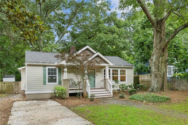 1735 Jobeth Ave SE, Atlanta, GA 30316 - view of front of house featuring a chimney, covered porch, and roof with shingles