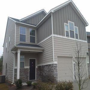 view of front of property with a garage and central air condition unit