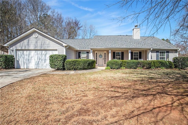 ranch-style house featuring a front yard, an attached garage, a shingled roof, a chimney, and concrete driveway