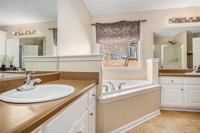 full bath featuring a shower stall, a garden tub, two vanities, tile patterned floors, and a sink