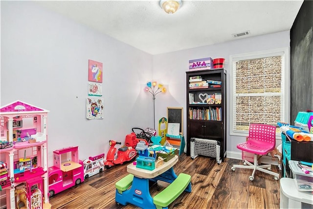 game room featuring visible vents, baseboards, and wood finished floors