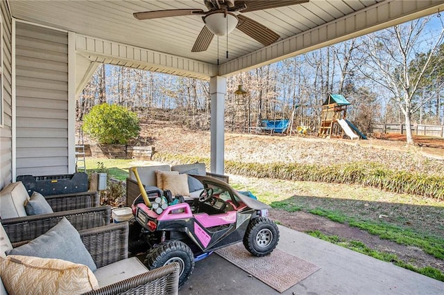 view of patio / terrace featuring a playground and a ceiling fan