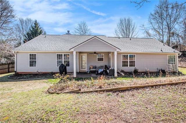 back of house with a yard, a patio area, ceiling fan, and roof with shingles