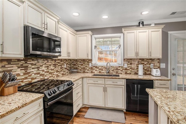 kitchen featuring stainless steel microwave, black range with electric stovetop, dishwasher, ornamental molding, and a sink