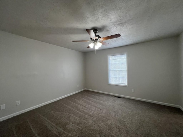 carpeted spare room with ceiling fan and a textured ceiling