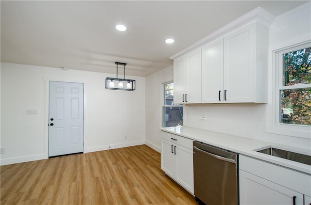 kitchen with decorative backsplash, white cabinetry, dishwasher, and pendant lighting