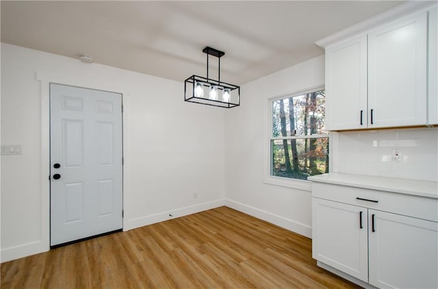 unfurnished dining area with light hardwood / wood-style flooring