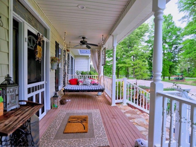 deck with a porch and ceiling fan