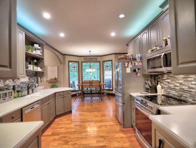 kitchen with a sink, decorative backsplash, stainless steel appliances, and recessed lighting