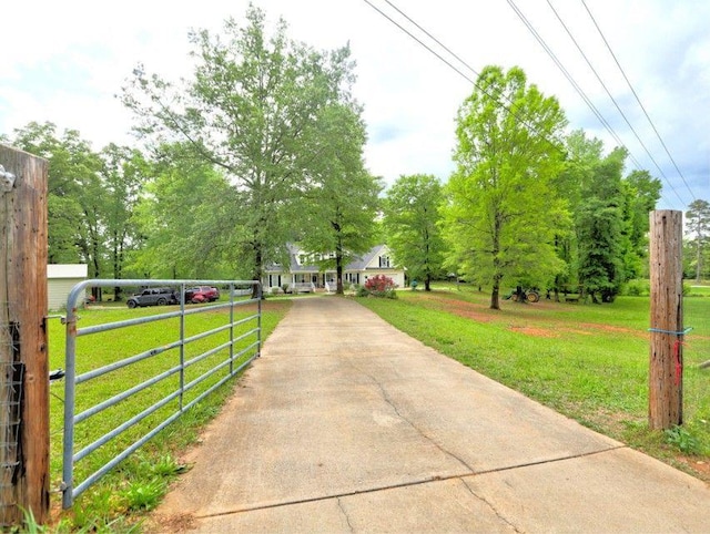 view of street featuring a gated entry and concrete driveway