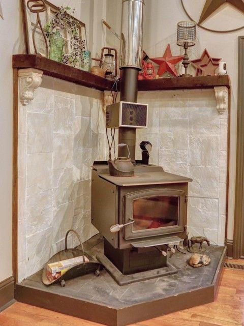 room details with a wood stove and wood finished floors