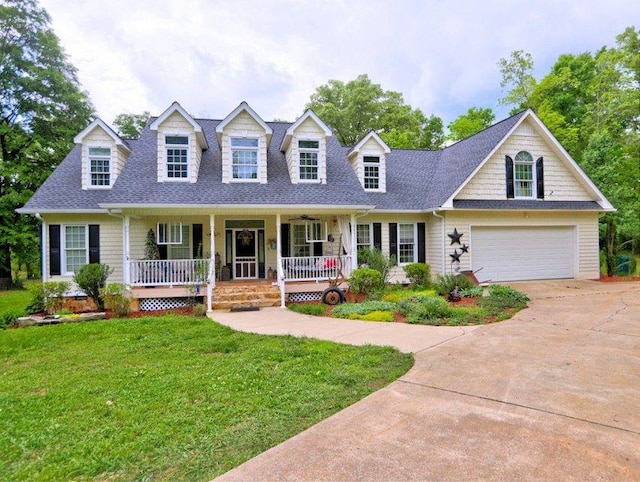 cape cod-style house featuring a porch, a front lawn, roof with shingles, and concrete driveway