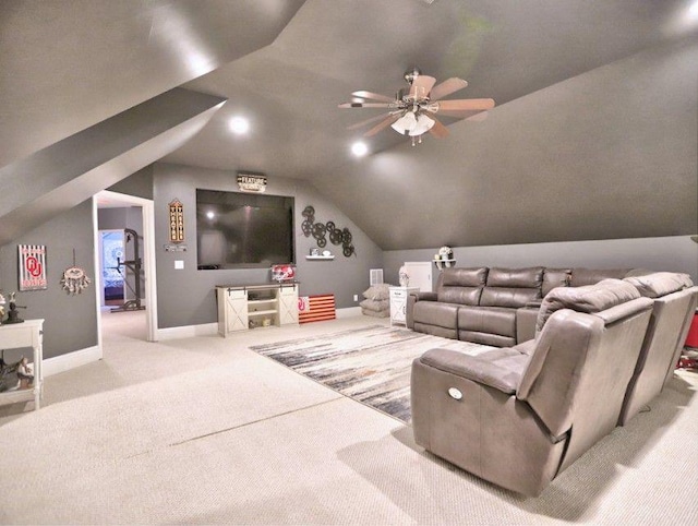 home theater room with carpet floors, a ceiling fan, baseboards, and vaulted ceiling