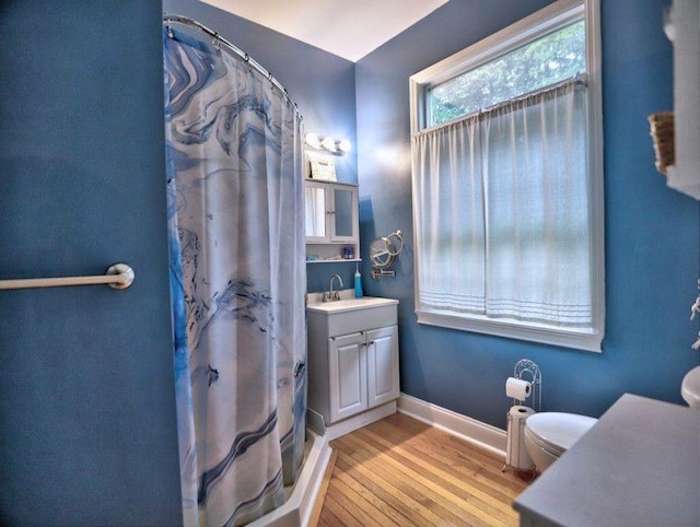 full bathroom featuring vanity, toilet, baseboards, wood finished floors, and a shower with curtain