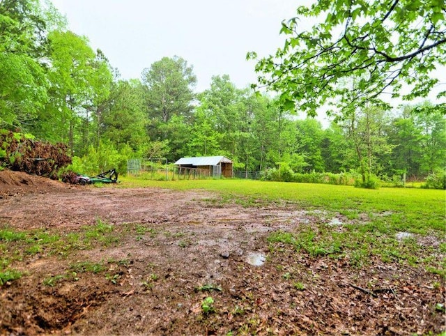 view of yard featuring fence and a view of trees