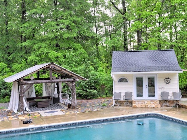 outdoor pool featuring a gazebo, outdoor lounge area, a patio area, and a storage structure