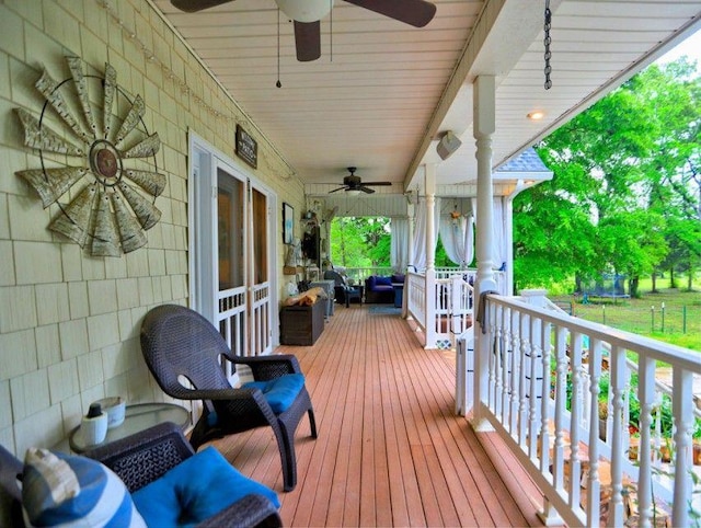 deck featuring a ceiling fan, a trampoline, and outdoor lounge area