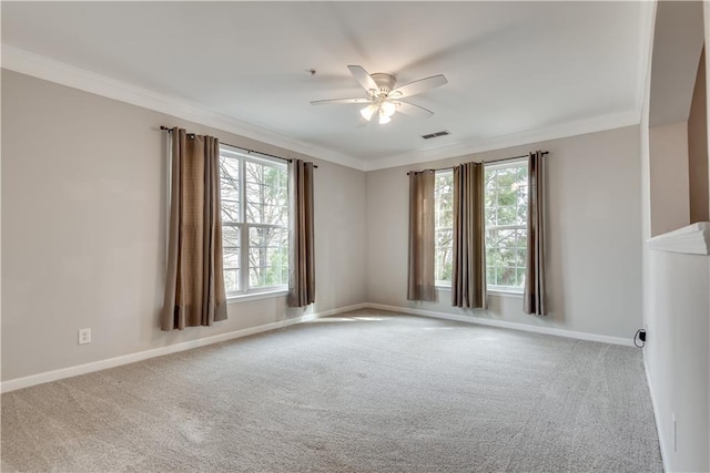 unfurnished room featuring baseboards, visible vents, and crown molding