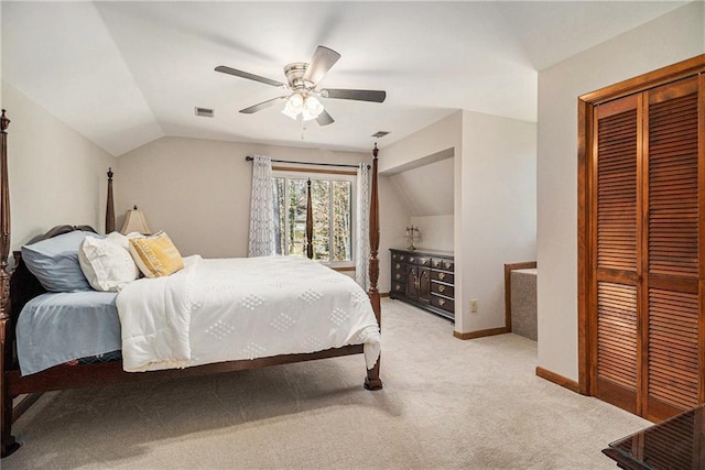 bedroom with light carpet, a ceiling fan, baseboards, vaulted ceiling, and a closet