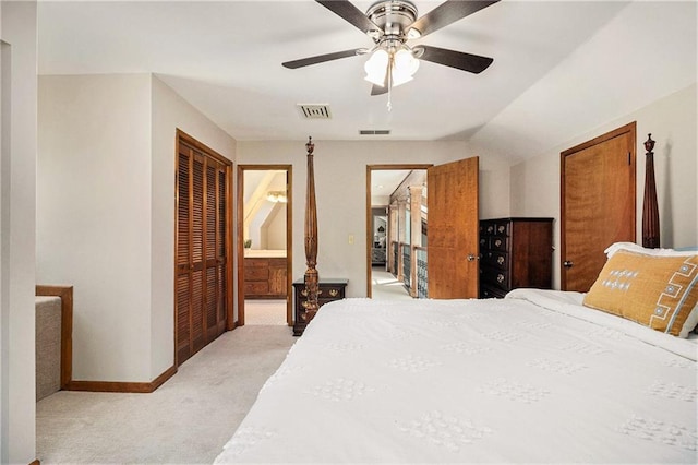 bedroom with light colored carpet, ensuite bath, visible vents, and baseboards