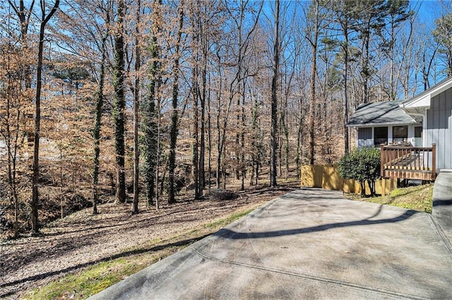 exterior space with a deck and concrete driveway