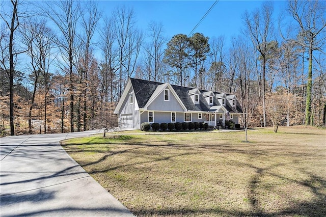 view of front of home with a garage, driveway, and a front lawn