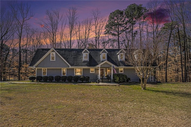 cape cod house featuring a front lawn