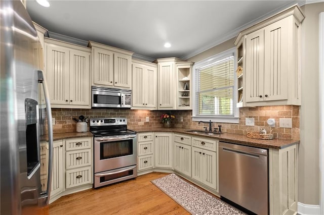 kitchen featuring open shelves, stainless steel appliances, dark stone counters, and cream cabinets