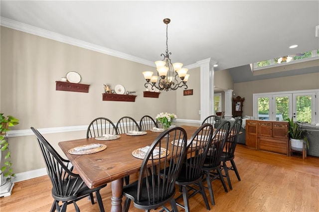 dining space with light wood finished floors, visible vents, crown molding, baseboards, and a chandelier