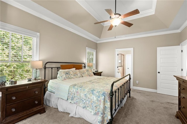 bedroom featuring light carpet, baseboards, a ceiling fan, ornamental molding, and a raised ceiling