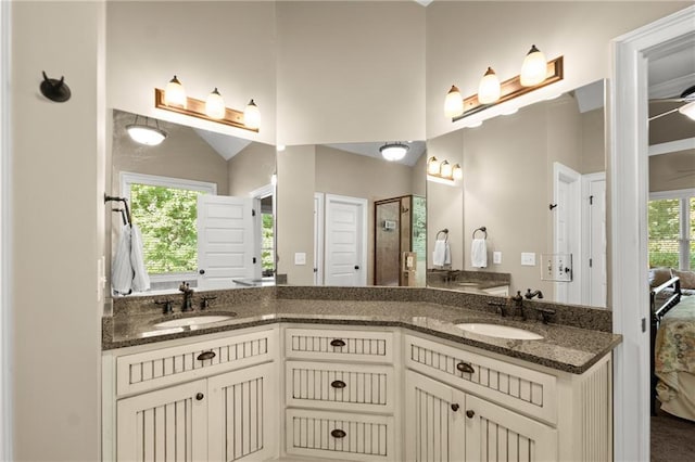 bathroom with double vanity, ensuite bathroom, and a sink