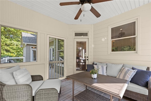 sunroom / solarium featuring ceiling fan and a healthy amount of sunlight
