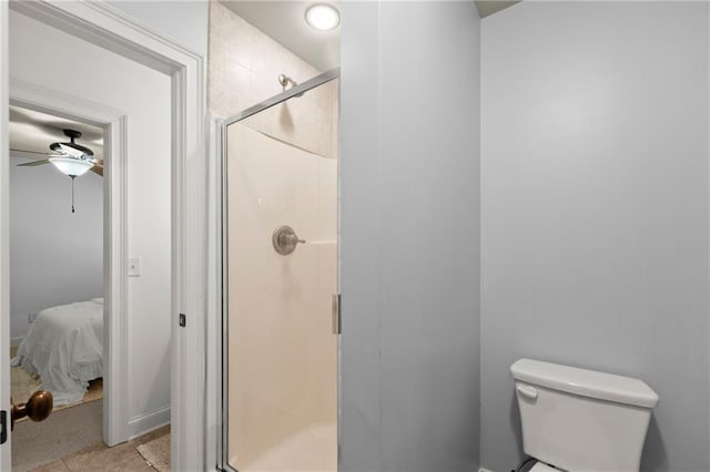 full bath with connected bathroom, a shower stall, ceiling fan, and toilet