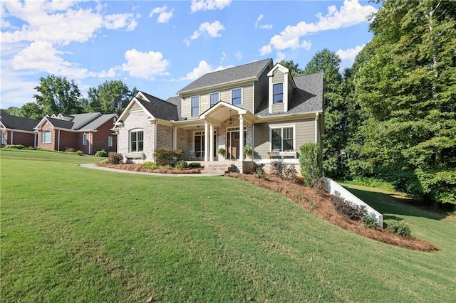 view of front of home with a front yard and covered porch