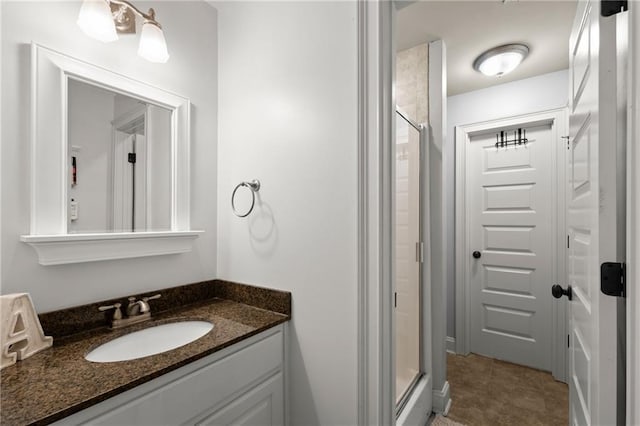 full bathroom featuring vanity, tile patterned flooring, and a shower stall