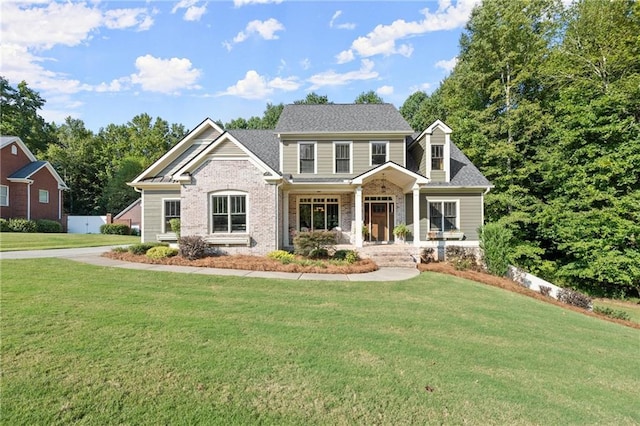 craftsman inspired home featuring a front lawn and a porch
