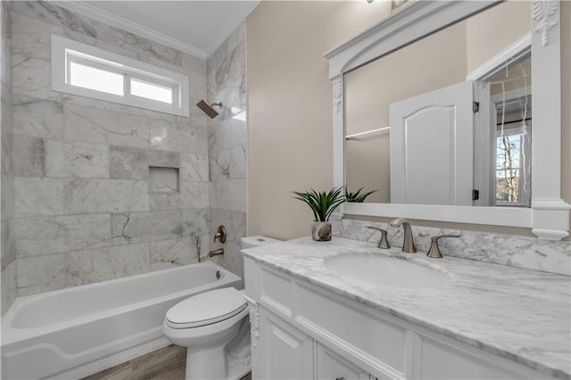 full bathroom featuring plenty of natural light, tiled shower / bath combo, ornamental molding, and vanity