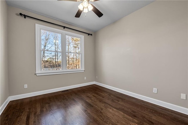 empty room featuring ceiling fan and dark hardwood / wood-style flooring