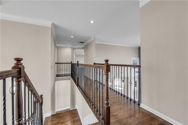 stairway with hardwood / wood-style floors and ornamental molding