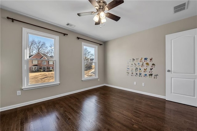 empty room featuring ceiling fan and dark hardwood / wood-style floors