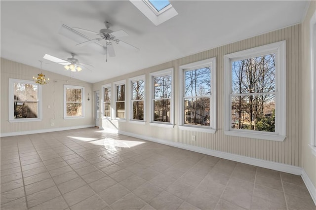 unfurnished sunroom featuring ceiling fan with notable chandelier and vaulted ceiling with skylight