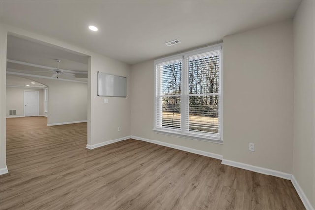 spare room with light hardwood / wood-style floors and ceiling fan