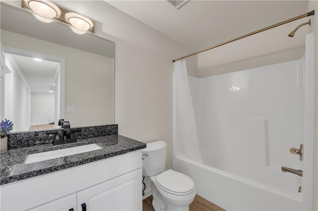 full bathroom featuring hardwood / wood-style flooring, toilet, vanity, and shower / bath combo