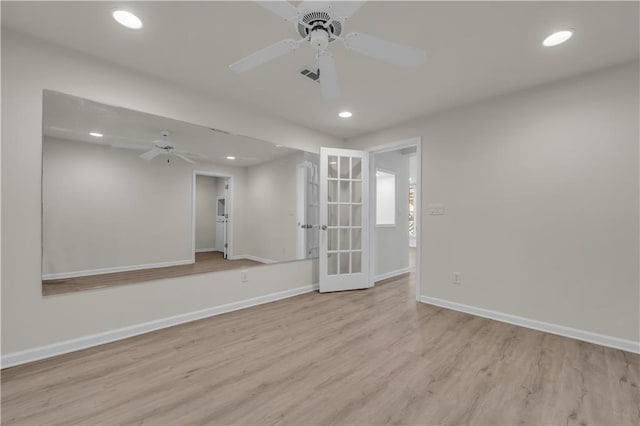 empty room with ceiling fan, french doors, and light hardwood / wood-style flooring