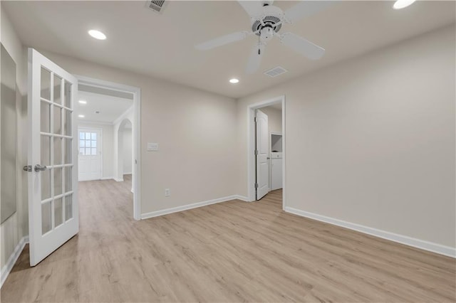 spare room featuring ceiling fan, light hardwood / wood-style flooring, and french doors