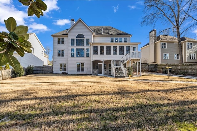 back of house featuring a lawn