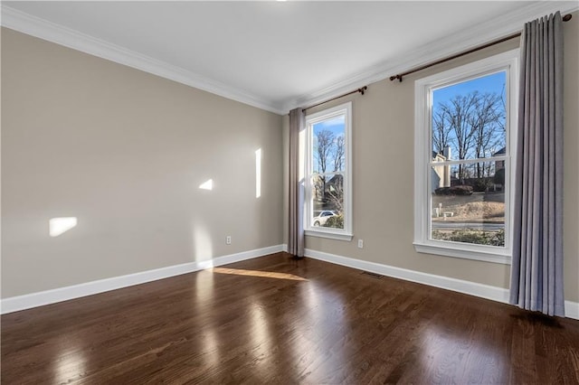 empty room featuring ornamental molding and dark wood-type flooring